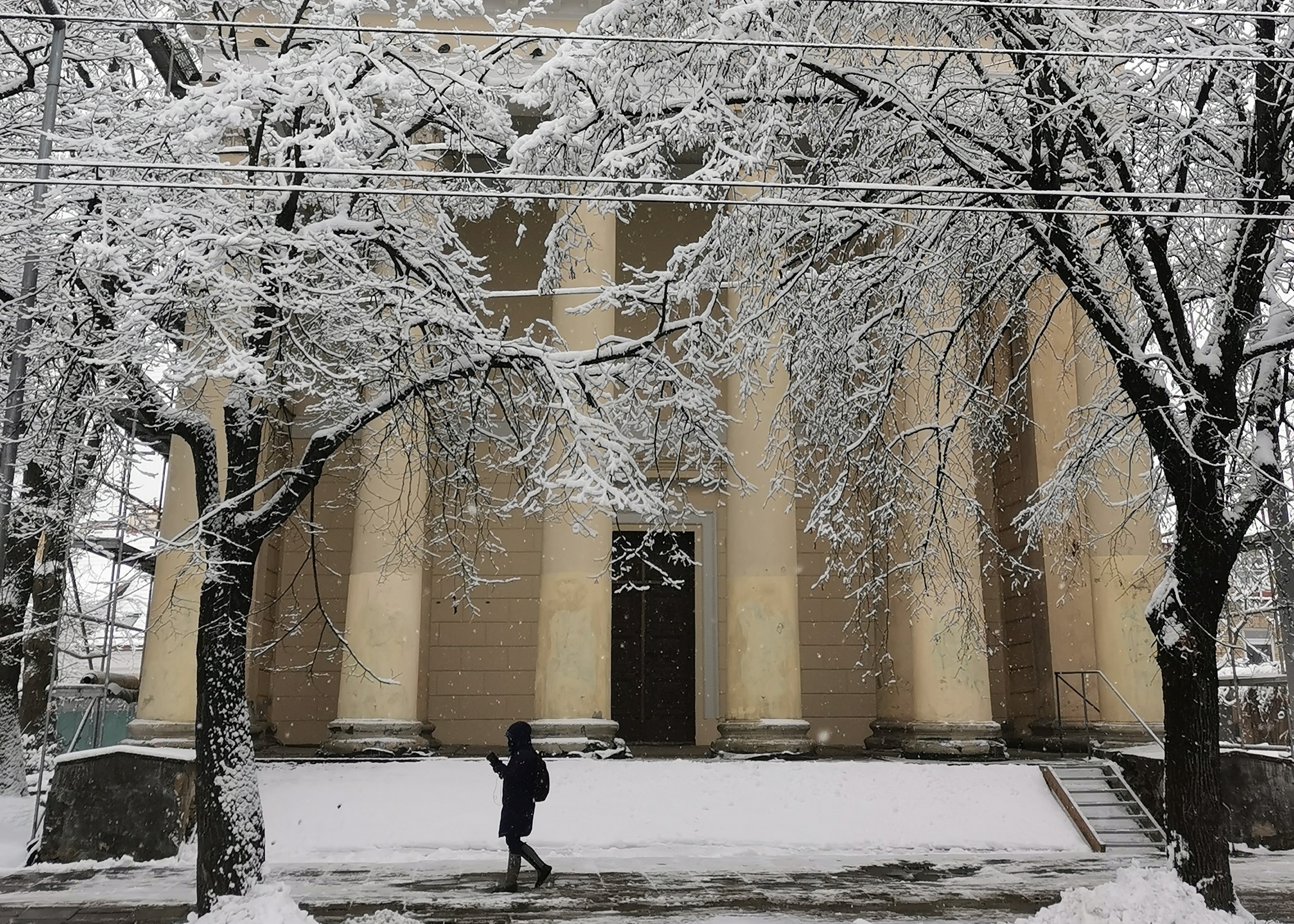 vilnius snow old town church people waling