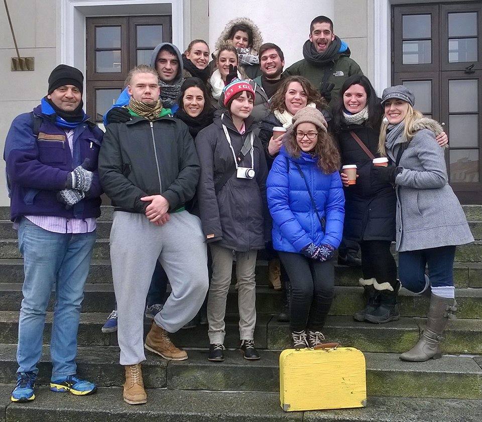 a group of tourists in Vilnius on town hall stairs