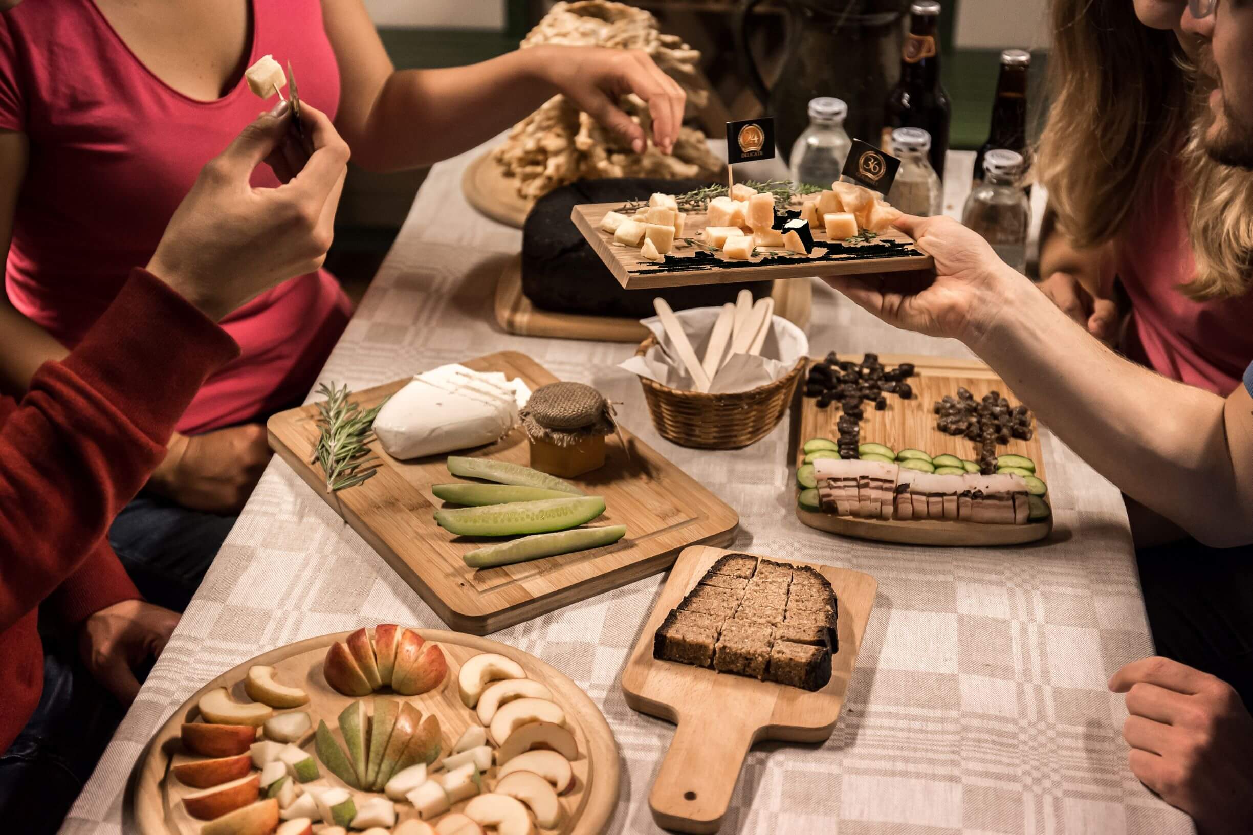 people tasting Lithuanian snacks like bread, cheese, cucumbers